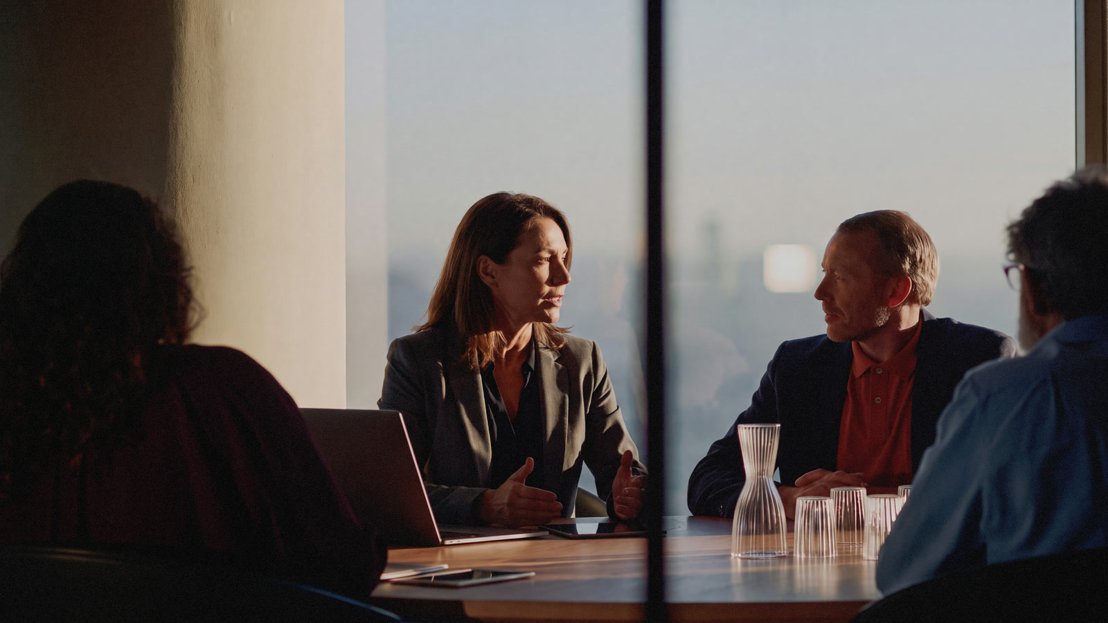 Advisors meeting around a table against a city skyline